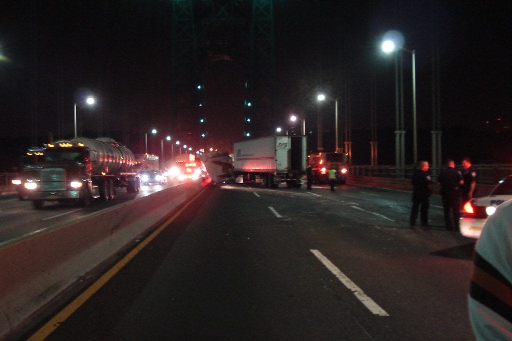 A distracted trucking driver caused a major accident on a main highway that crashed into the median and another vehicle causing personal injury to the victim.