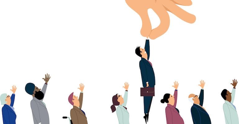 Huge cartoon hand on top holding an employee by the hand picking him up with a suit and briefcase. There are several types of employees in front and behind with their hand up, waiting to be picked up. 